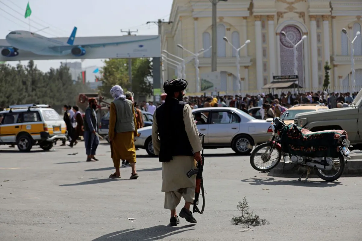 Taliban fighters stand guard in front of the Hamid Karzai International Airport, in Kabul, Afghanistan, on Aug. 16, 2021. (Rahmat Gul/AP Photo)