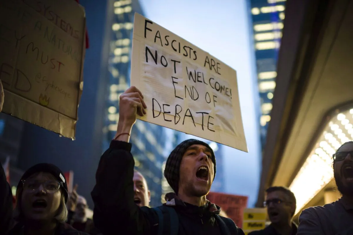 Protesters demonstrate outside a Munk Debate featuring political strategist and filmmaker Steve Bannon and political commentator and author David Frum in Toronto on Nov. 2, 2018. (The Canadian Press/Christopher Katsarov)