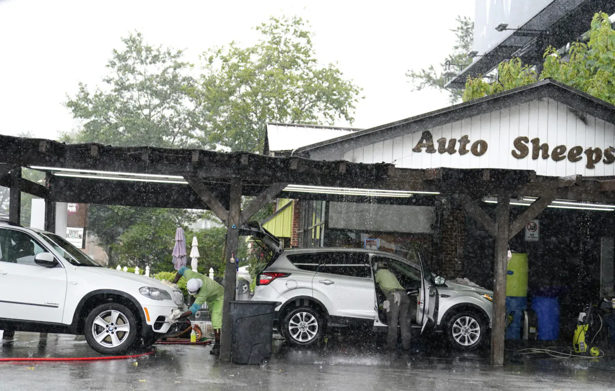 People wash and dry cars as it stores near Atlanta, while hurricane Fred makes its way through north and central Georgia on Aug. 17, 2021. (Brynn Anderson/AP Photo)