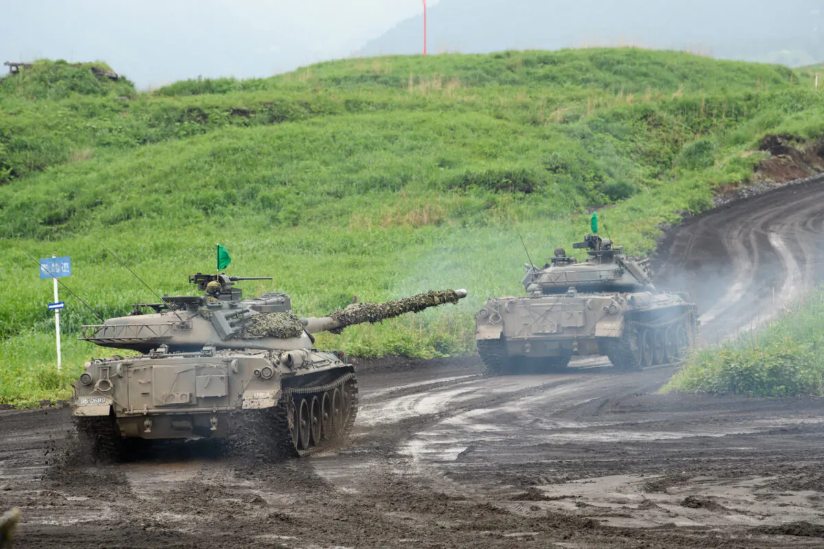 Japan's Ground Self-Defense Forces (JGSDF) Type-74 tanks move during a live fire exercise at JGSDF's training grounds in the East Fuji Maneuver Area on May 22, 2021 in Gotemba, Shizuoka, Japan. (Akio Kon - Pool/Getty Images)