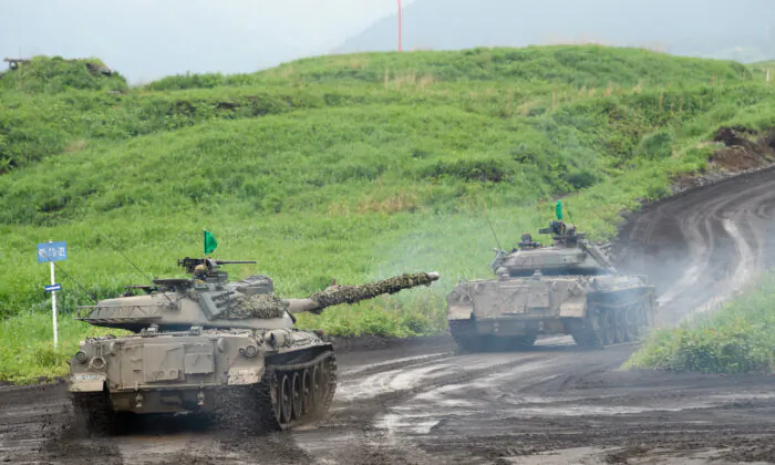 Japan's Ground Self-Defense Forces (JGSDF) Type-74 tanks move during a live fire exercise at JGSDF's training grounds in the East Fuji Maneuver Area on May 22, 2021 in Gotemba, Shizuoka, Japan.  (Akio Kon - Pool/Getty Images)