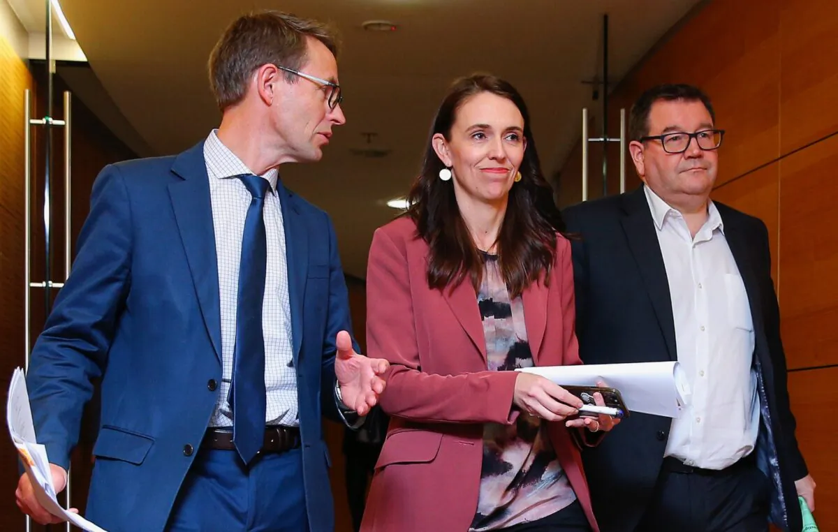 (L-R) Director-General of Health Dr Ashley Bloomfield, then-Prime Minister Jacinda Ardern, and Minister of Finance Grant Robertson arrive at a press conference at Parliament in Wellington, New Zealand, on Aug. 17, 2021. (Hagen Hopkins/Getty Images)
