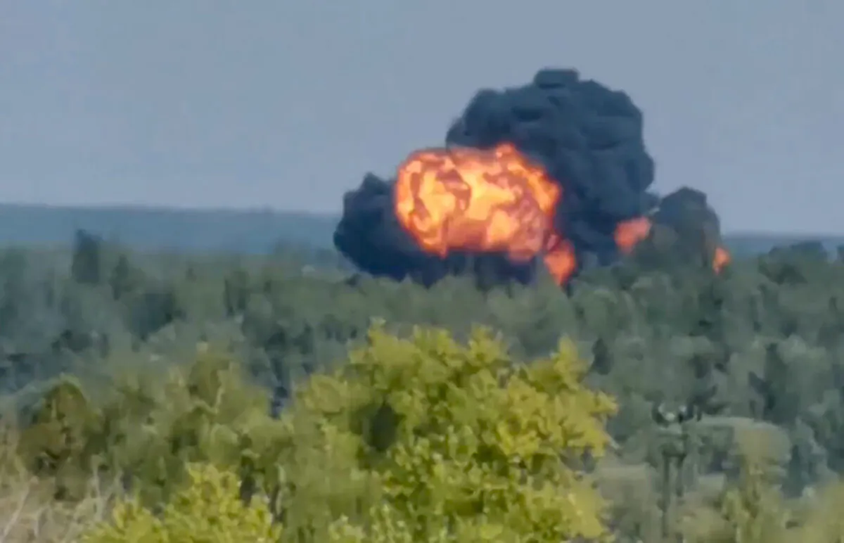 In this handout photo taken from video, flame and smoke rise from the place where the new light military transport plane Il-112V crashes near Kubinka airfield about 45 kilometers (28 miles) west of Moscow, Russia, on Aug. 17, 2021. (Dmitry Ovchinnikov via AP)