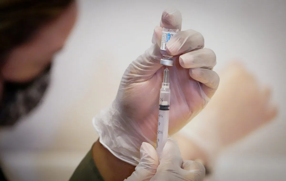 A healthcare worker prepares a dose of the Johnson & Johnson COVID-19 vaccine during the opening of the MTA's public vaccination program at Grand Central Terminal train station in Manhattan in New York City on May 12, 2021. (Carlo Allegri/Reuters)