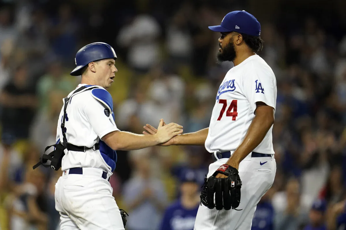 Los Angeles Dodgers catcher Will Smith and relief pitcher Kenley Jansen (74) celebrate the team's 4-3 win over the Pittsburgh Pirates in a baseball game in Los Angeles on Aug. 17, 2021. (AP Photo/Marcio Jose Sanchez)