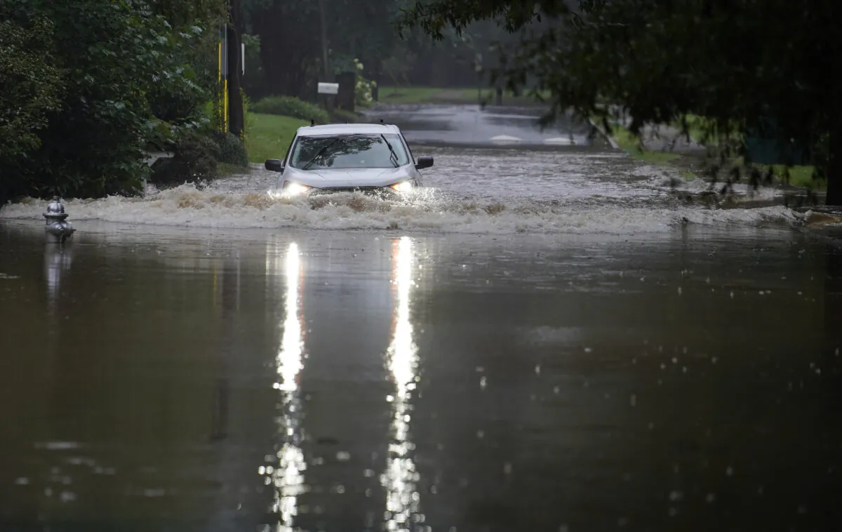 A car attempts to drive through flood waters near Peachtree Creek near Atlanta, Ga., on Aug. 17, 2021. (Brynn Anderson/AP Photo)