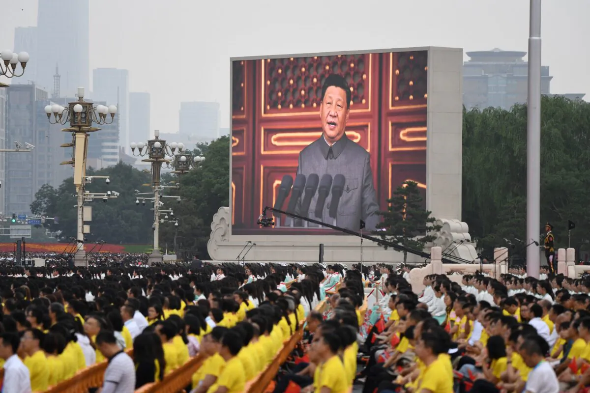 Chinese leader Xi Jinping (on screen) delivers a speech during the celebrations of the 100th anniversary of the founding of the Communist Party of China at Tiananmen Square in Beijing on July 1, 2021. (Wang Zhao/AFP via Getty Images)