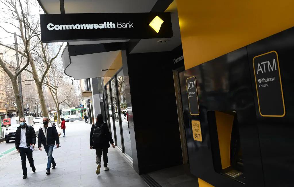 People walk past a branch of the Commonwealth Bank of Australia (CBA) branch in Melbourne, Australia, on Aug. 11, 2021. (William West/AFP via Getty Images)
