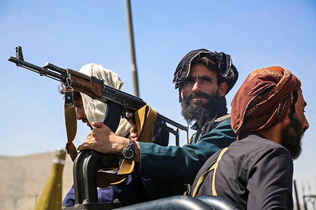 Taliban fighters stand guard in a vehicle along the roadside in Kabul on Aug.16, 2021, after a stunningly swift end to Afghanistan's 20-year war, as thousands of people mobbed the city's airport trying to flee the group's feared hardline brand of Islamist rule. (AFP via Getty Images)