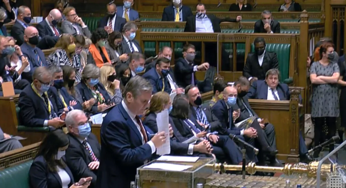 Labour MPs, most wearing face masks, sit behind their leader Kier Starmer during a debate in the House of Commons on Aug. 18. 2021. (Parliament TV)