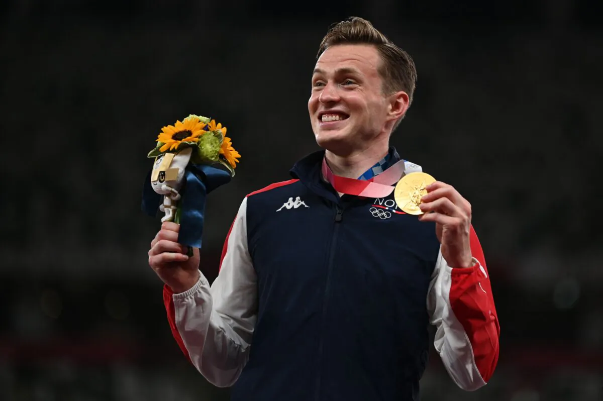 Norway's Karsten Warholm, Gold medallist,   poses on the podium after the men's 400m hurdles event during the Tokyo 2020 Olympic Games at the Olympic Stadium in Tokyo on Aug. 3, 2021. (Charly Triballeau/AFP via Getty Images)