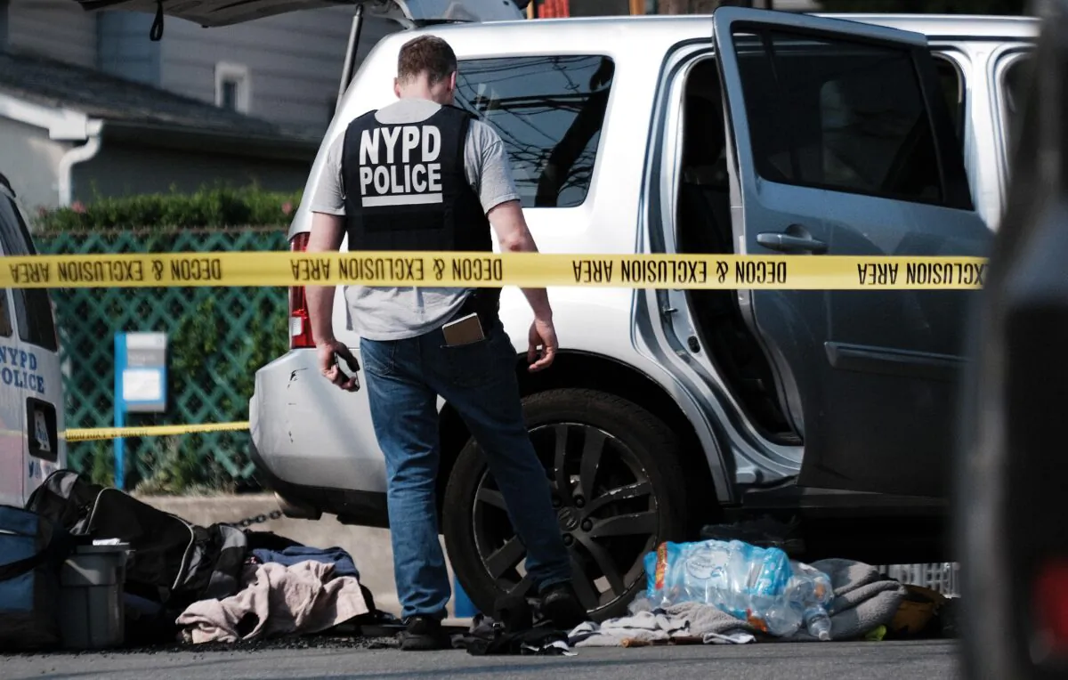 Police search a car following a stand-off in front of the 45th Police Precinct in the Bronx in New York City on July 8, 2021. (Spencer Platt/Getty Images)