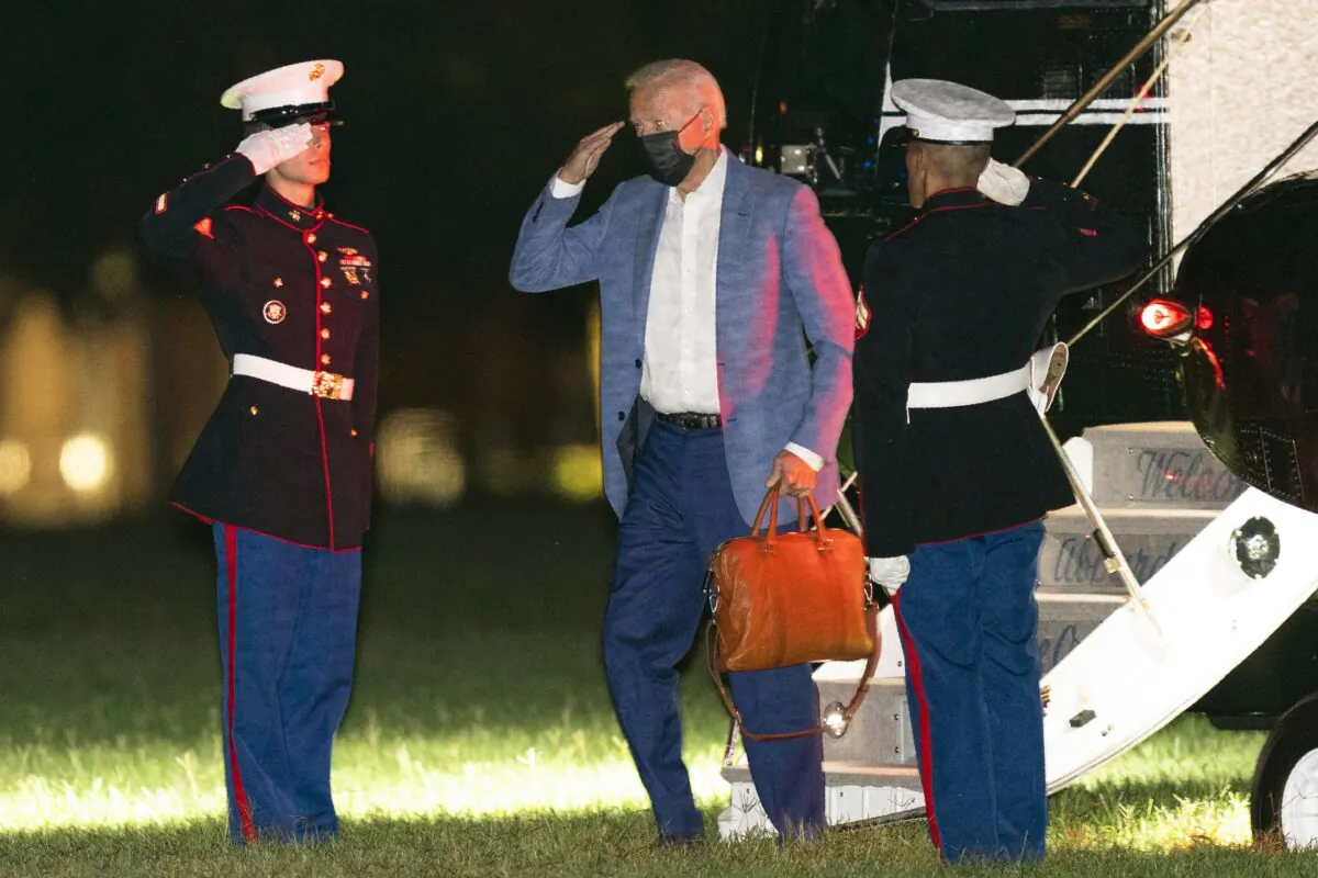 President Joe Biden salutes as he disembarks from Marine One at Fort McNair in Washington after flying from Camp David, on Aug. 17, 2021. (Manuel Balce Ceneta/AP Photo)