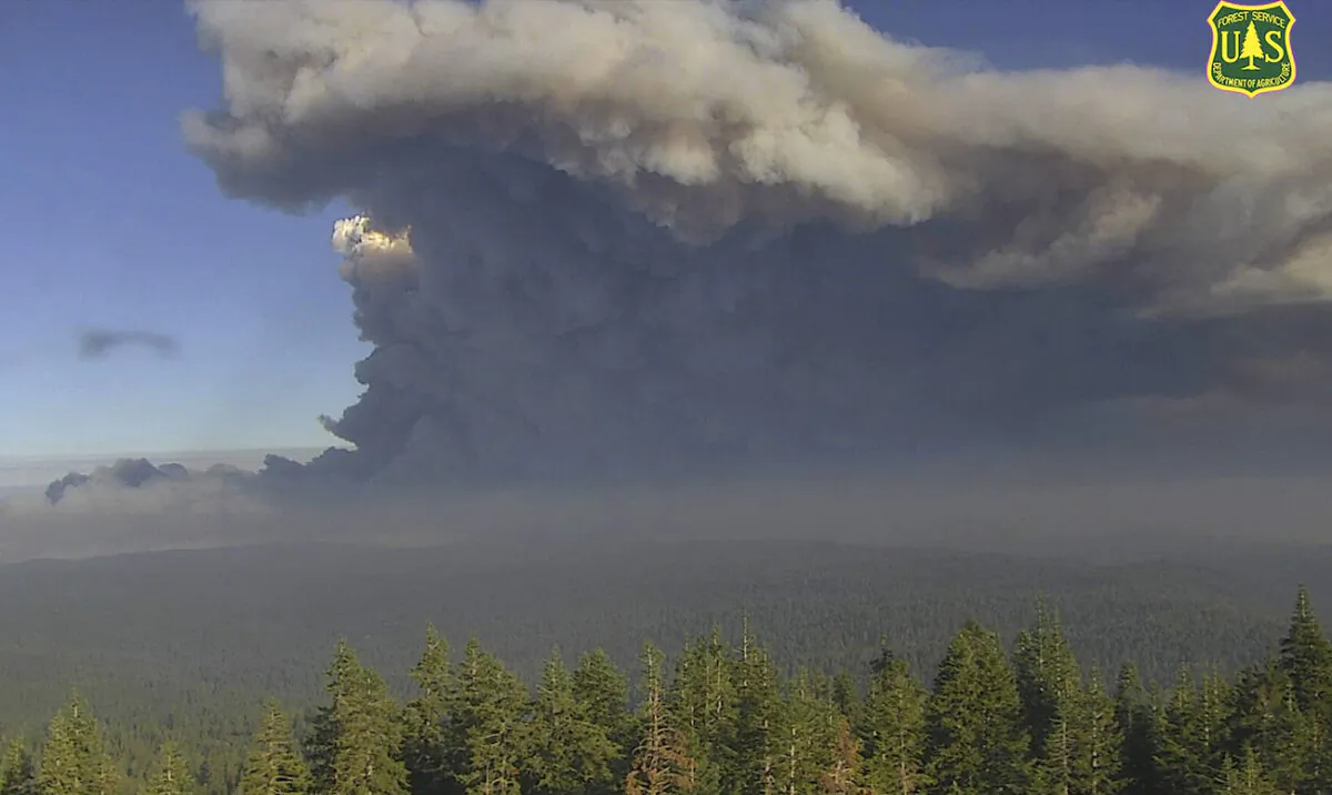 In this image from a U.S. Forest Service wildfire monitoring camera, plumes of smoke rise from the Caldor Fire in El Dorado County, Calif., on Aug. 17, 2021. (U.S. Forest Service/ALERTWildfire Network via AP)
