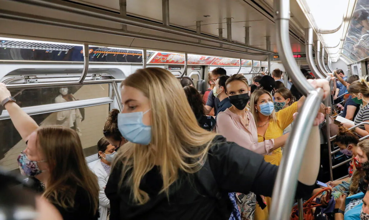 People wear masks while riding on the subway in New York City on Aug. 2, 2021. (Andrew Kelly/Reuters)