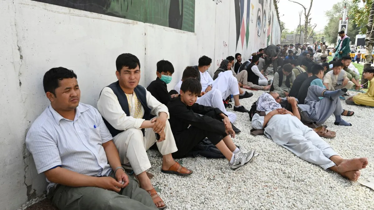 People sit near the French embassy in Kabul on Aug. 18, 2021. (Wakil Kohsar/AFP via Getty Images)