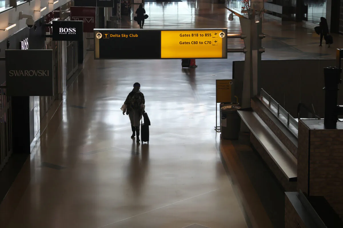 Air travelers walk through a terminal as the COVID-19 outbreak continues, at New York’s JFK International Airport in New York, May 15, 2020. (Shannon Stapleton/Reuters)