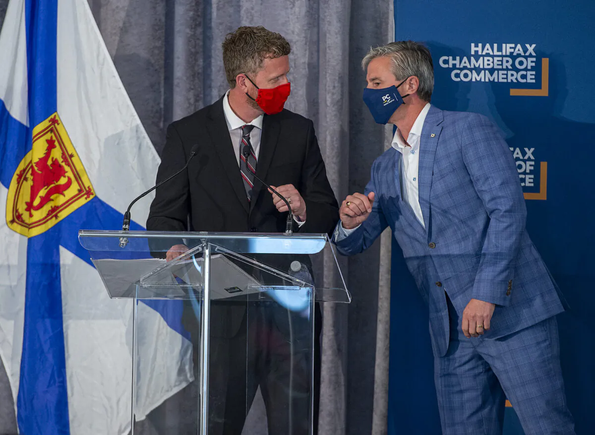 Nova Scotia Liberal Leader Iain Rankin (L) and Progressive Conservative Leader Tim Houston bump elbows at a Halifax Chamber of Commerce pre-election event in Halifax on Aug. 4, 2021. (The Canadian Press/Andrew Vaughan)