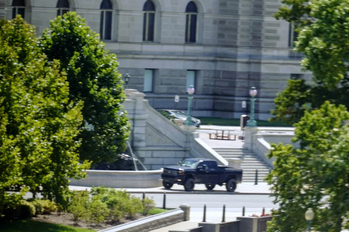 A pickup truck is parked on the sidewalk in front of the Library of Congress' Thomas Jefferson Building, as seen from a window of the U.S. Capitol in Washington, on Aug. 19, 2021. (Alex Brandon/AP Photo)