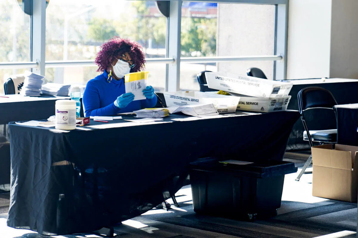An election worker processes absentee ballots at State Farm Arena in Atlanta, Georgia, on Nov. 2, 2020. (Megan Varner/Getty Images)