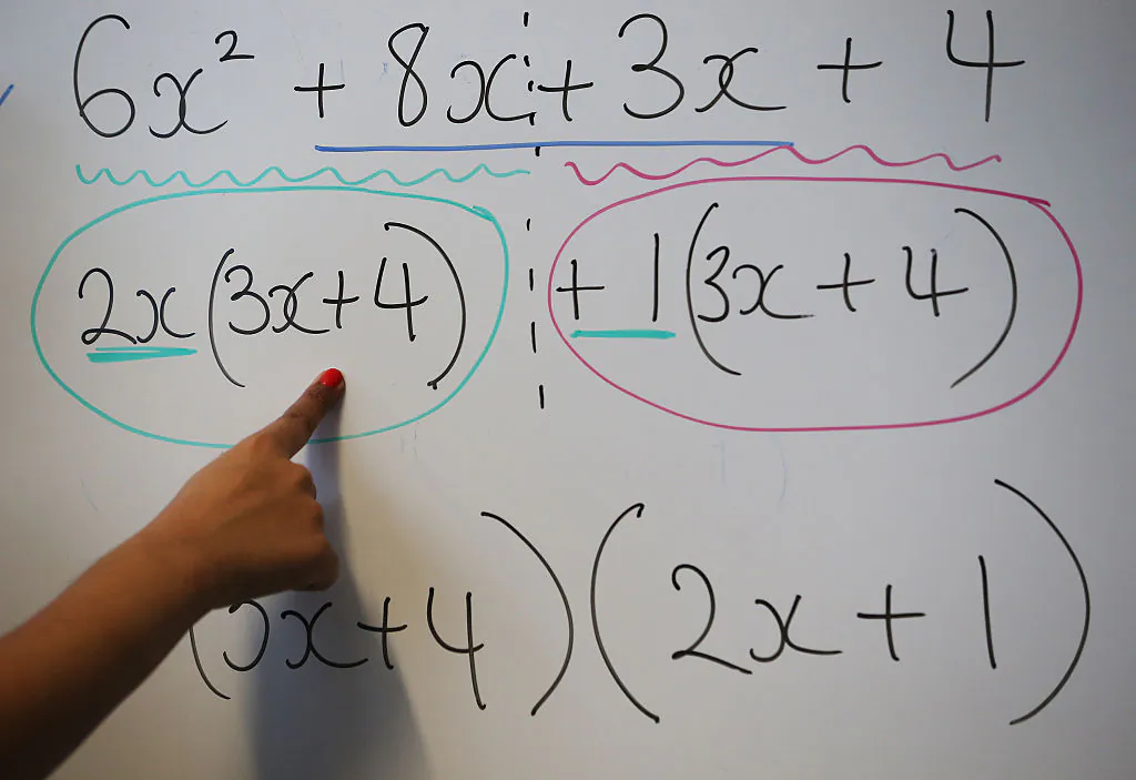 A teacher writes an equation on a whiteboard during a maths lesson at a secondary school in London, England, on Dec. 1, 2014. (Peter Macdiarmid/Getty Images)