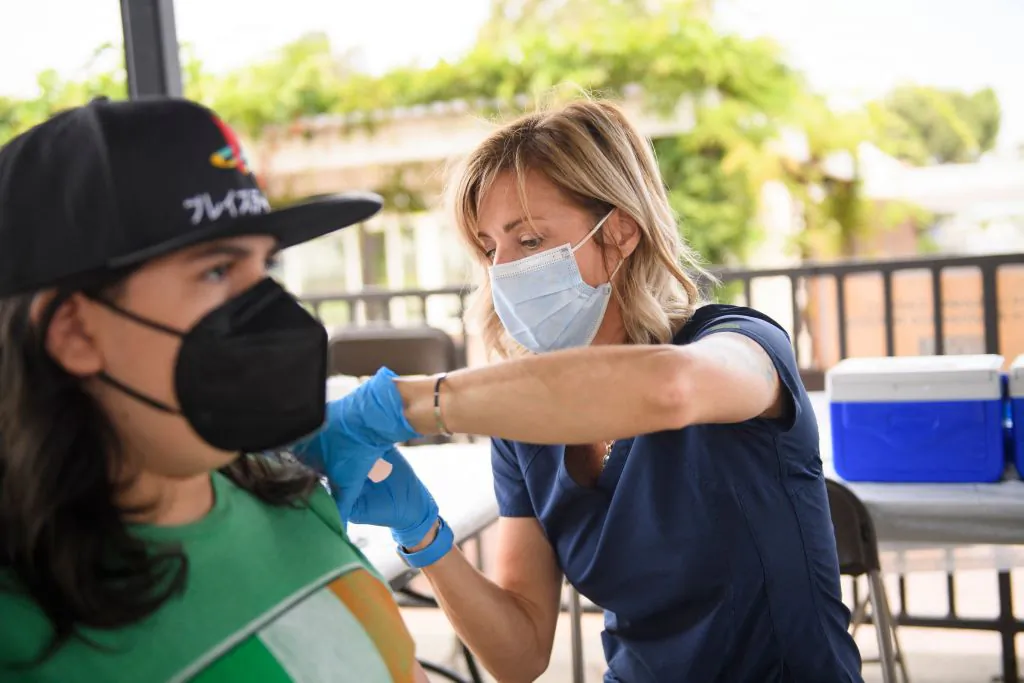 A nurse administers a dose of the Pfizer COVID-19 vaccine to a high school student at the California State University Long Beach campus in Long Beach, Calif., on Aug. 11, 2021. (Patrick T. Fallon/AFP via Getty Images)