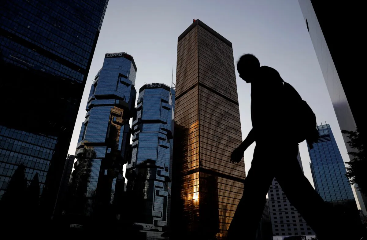 A man walks past buildings at a business district in Hong Kong, on Nov. 4, 2019. (Kim Kyung-Hoon/Reuters)