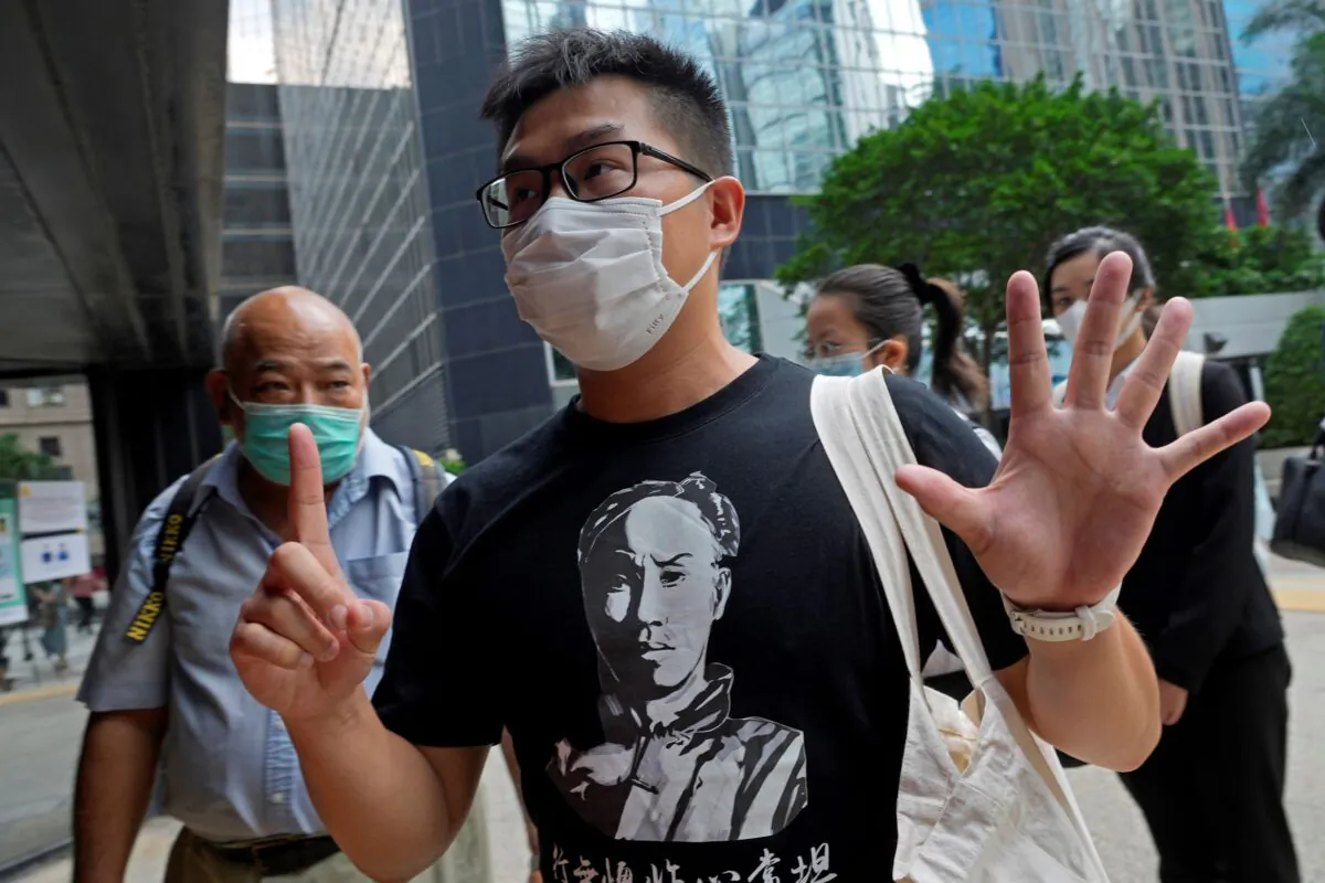 Pro-democracy activist Raphael Wong gestures, signifying "Five demands—not one less," outside a local court in Hong Kong on Aug. 19, 2021. (Vincent Yu/AP Photo)