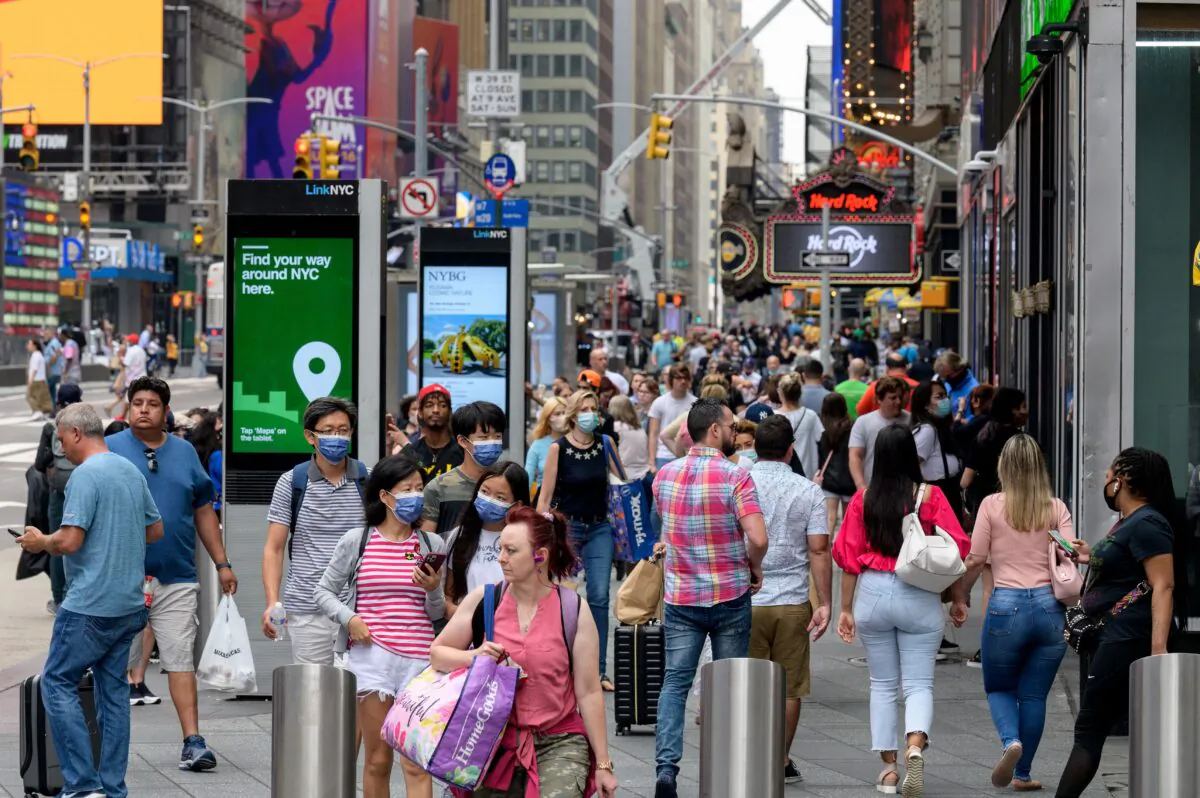 People walk through Times Square in New York City on July 13, 2021. (Angela Weiss/AFP via Getty Images)