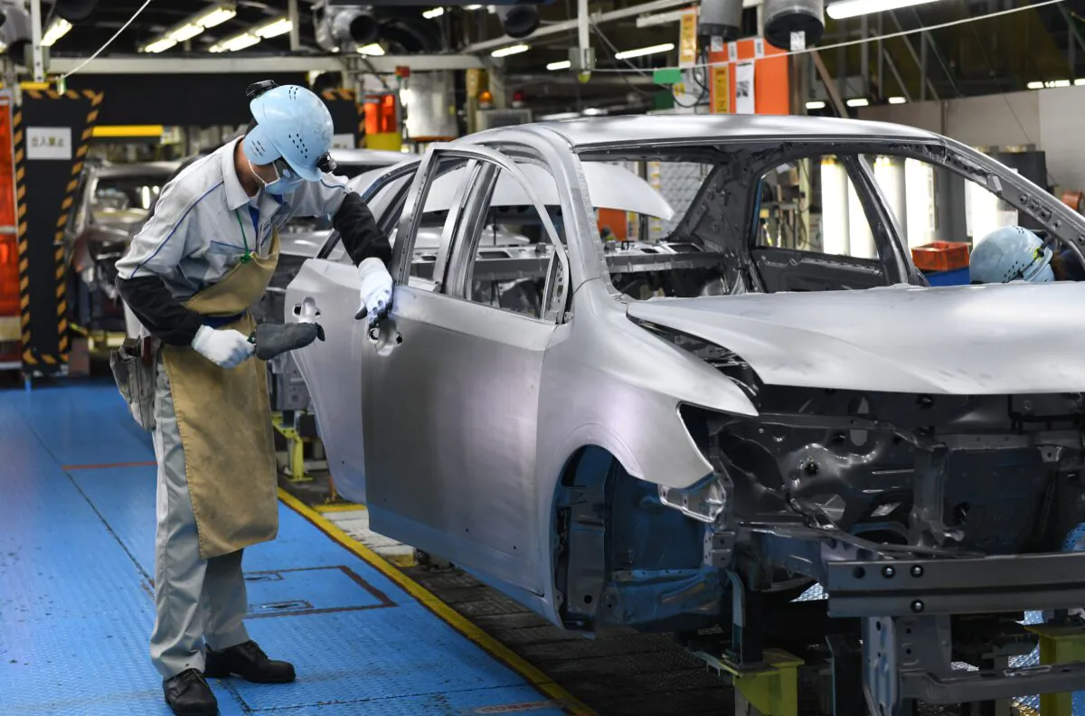 Workers assembling fourth generation Toyota Prius cars on the production line at the company's Tsutsumi assembly plant in Toyota City, Aichi prefecture, on Dec. 8, 2017. (Toshifumi Kitamura/AFP via Getty Images)
