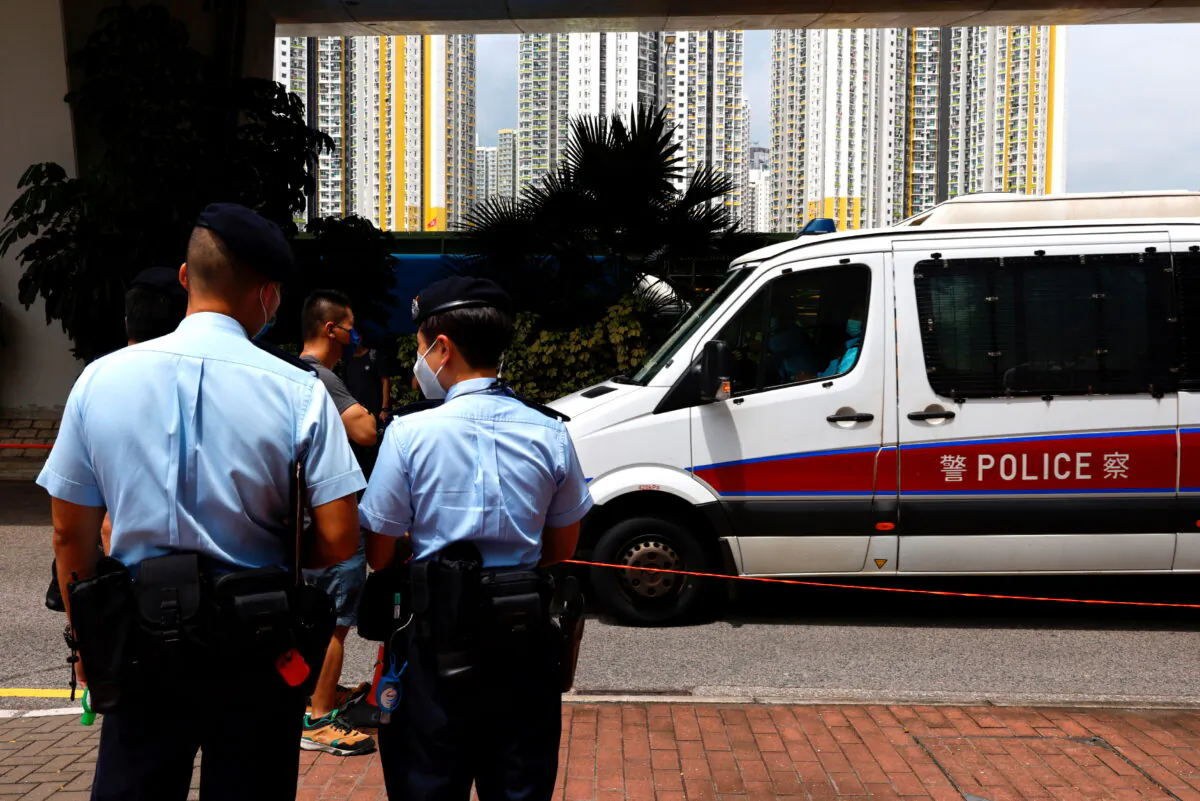 A police van carries a member of Hong Kong University Student Union to West Kowloon Magistrates' Courts building over national security law in Hong Kong, on Aug. 19, 2021. (Tyrone Siu/Reuters)