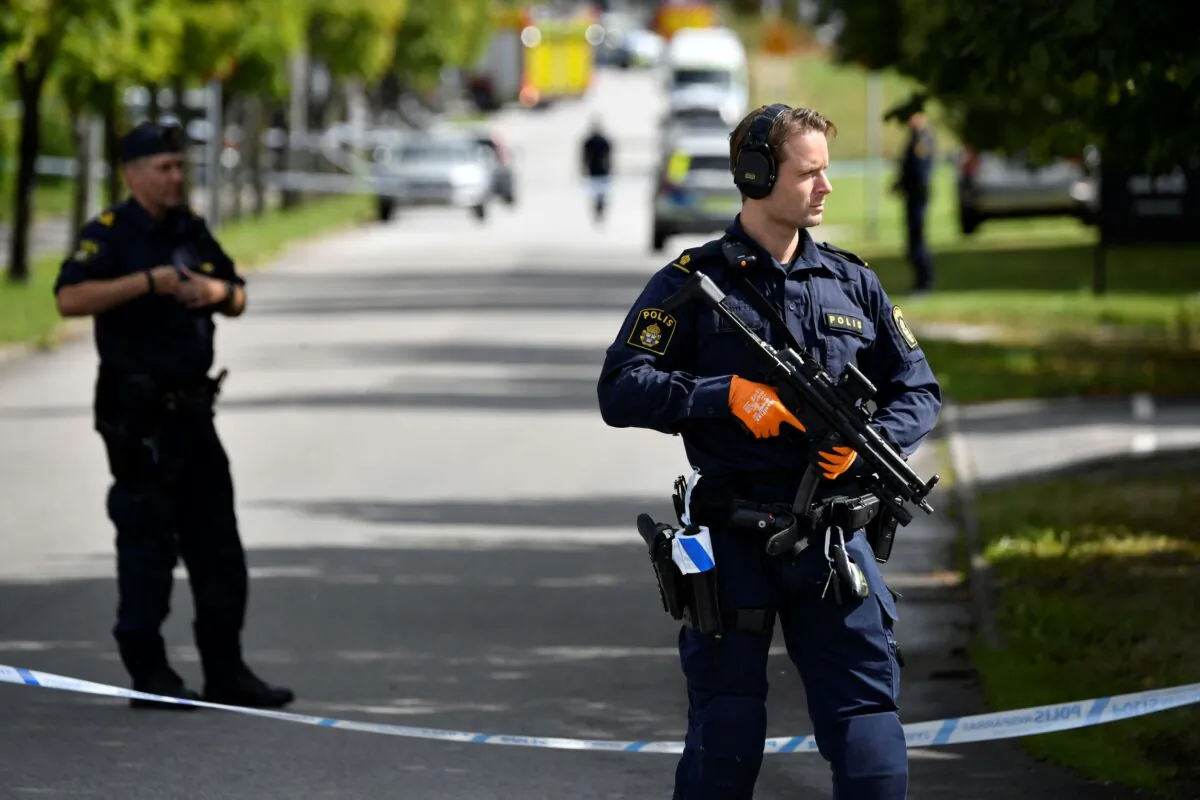 Police stand guard at the scene of an attack at a high school, in Eslov, Sweden, on Aug. 19, 2021. (Johan Nilsson/TT News Agency via AP)