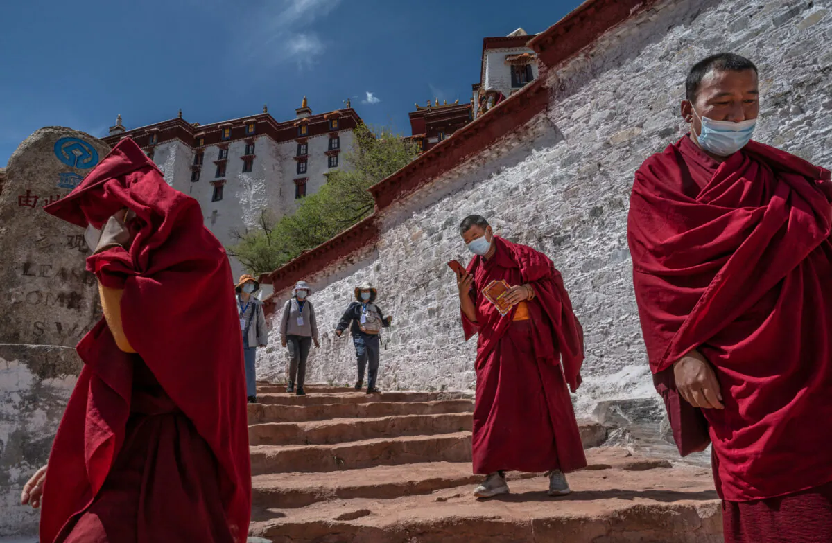 Tourists visit the Potala Palace, a UNESCO heritage site, during a government organized visit for journalists in Lhasa, Tibet, China, on June 1, 2021. (Kevin Frayer/Getty Images)