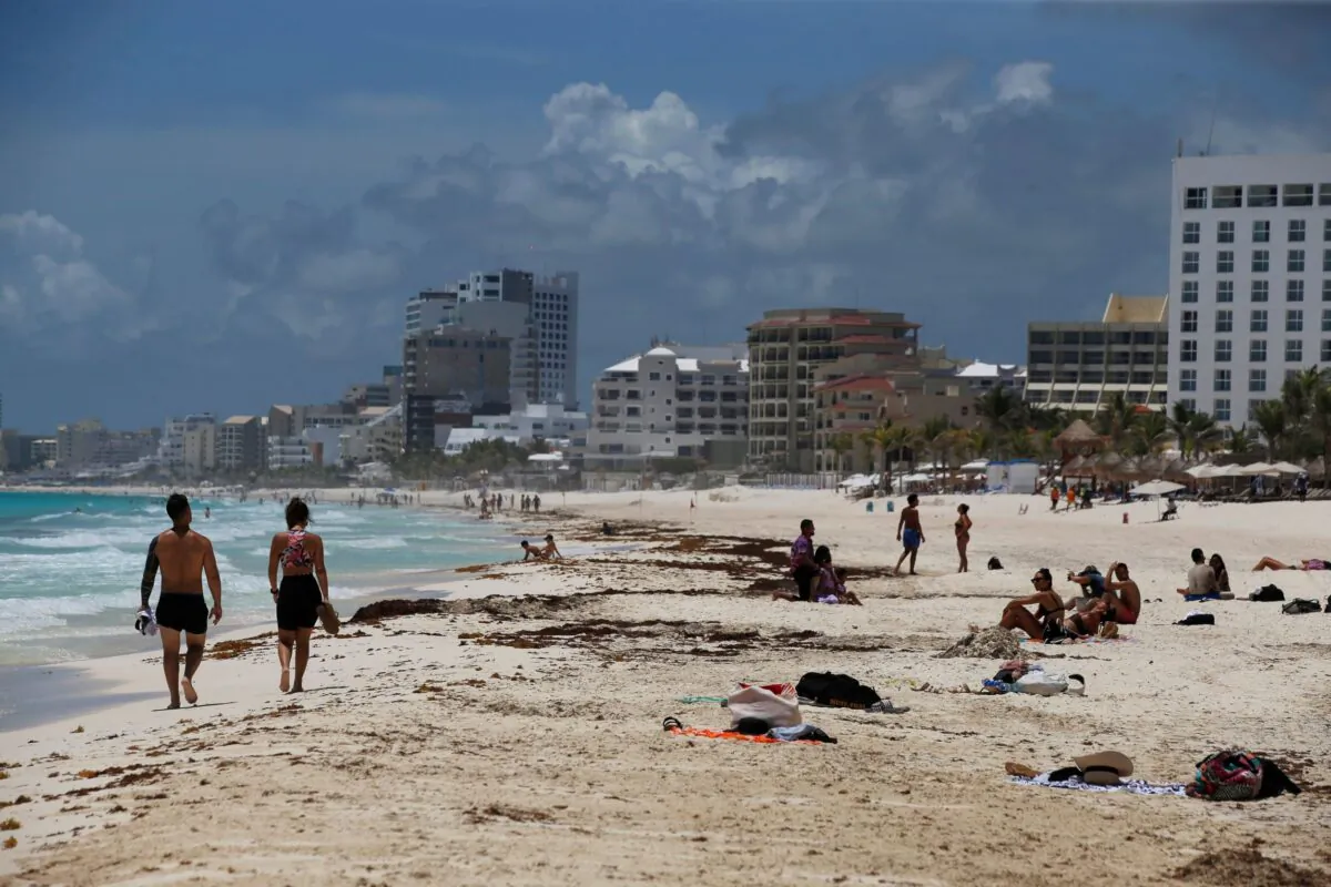 Tourists enjoy the beach Cancun, Quintana Roo State, Mexico, on Aug. 18, 2021. (Marco Ugarte/AP Photo)