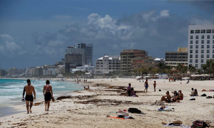 Tourists enjoy the beach Cancun, Quintana Roo State, Mexico, on Aug. 18, 2021. (Marco Ugarte/AP Photo)