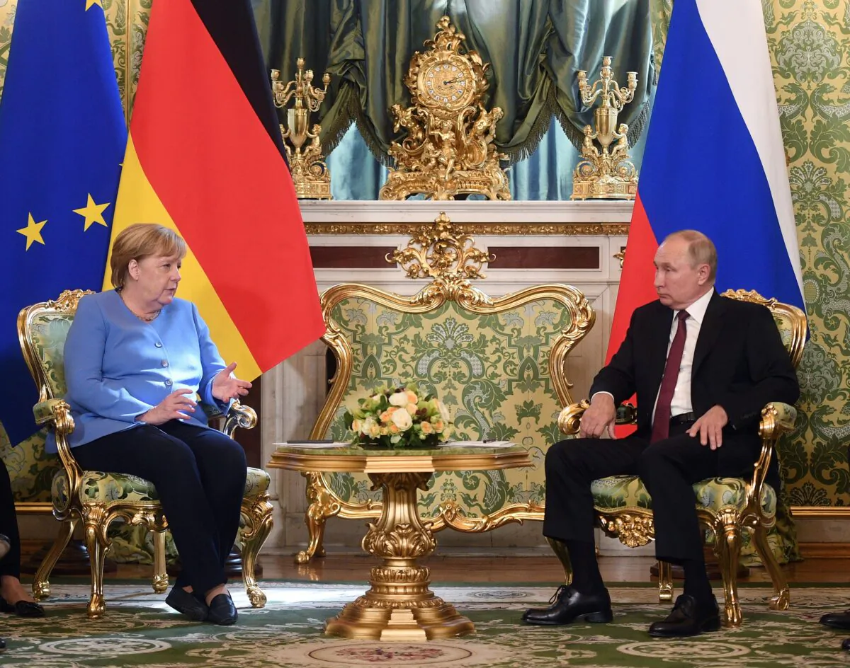 German Chancellor Angela Merkel and Russian President Vladimir Putin talk during their meeting in the Kremlin in Moscow, Russia, on Aug. 20, 2021. (Evgeny Odinokov, Sputnik, Kremlin/Pool Photo via AP)