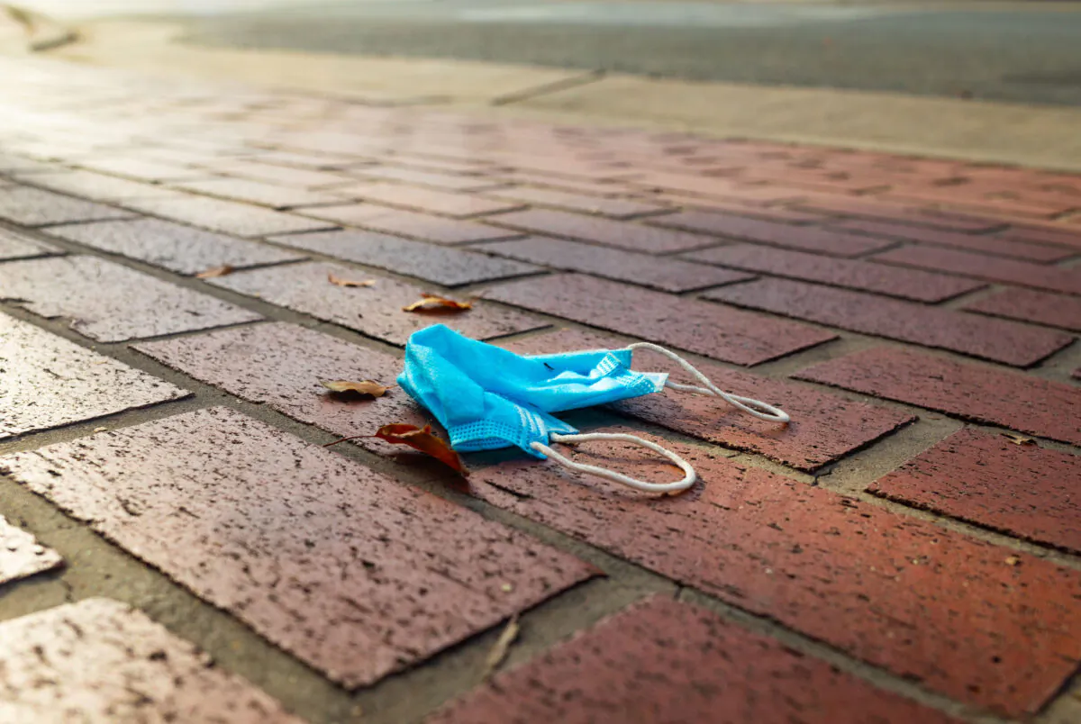 A face mask on the ground in a file photograph. (John Fredricks/The Epoch Times)