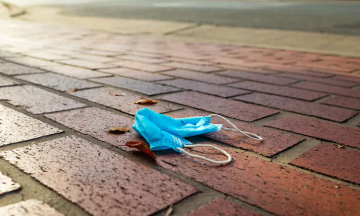 A face mask lies on the ground in a file photograph. (John Fredricks/The Epoch Times)