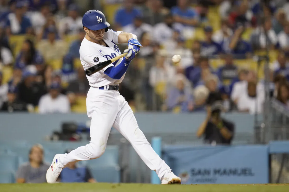 Los Angeles Dodgers' Trea Turner singles during the third inning of a baseball game against the New York Mets in Los Angeles on Aug. 19, 2021. (AP Photo/Ashley Landis)