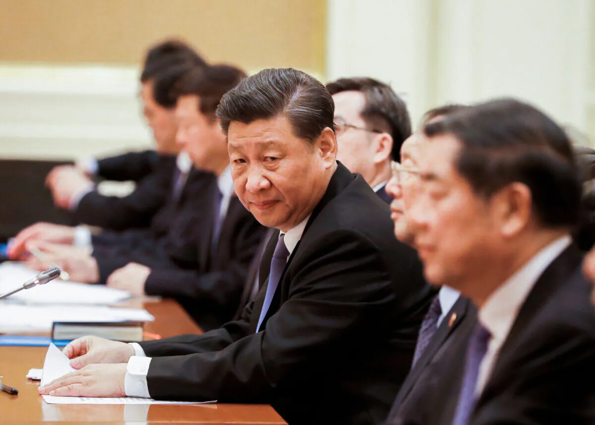 Chinese President Xi Jinping (C) attends a bilateral meeting with Myanmar State Counselor Aung San Suu Kyi (not pictured) at the Presidential Palace in Naypyidaw, Burma, on Jan. 18, 2020. (NYEIN CHAN NAING/POOL/AFP via Getty Images)