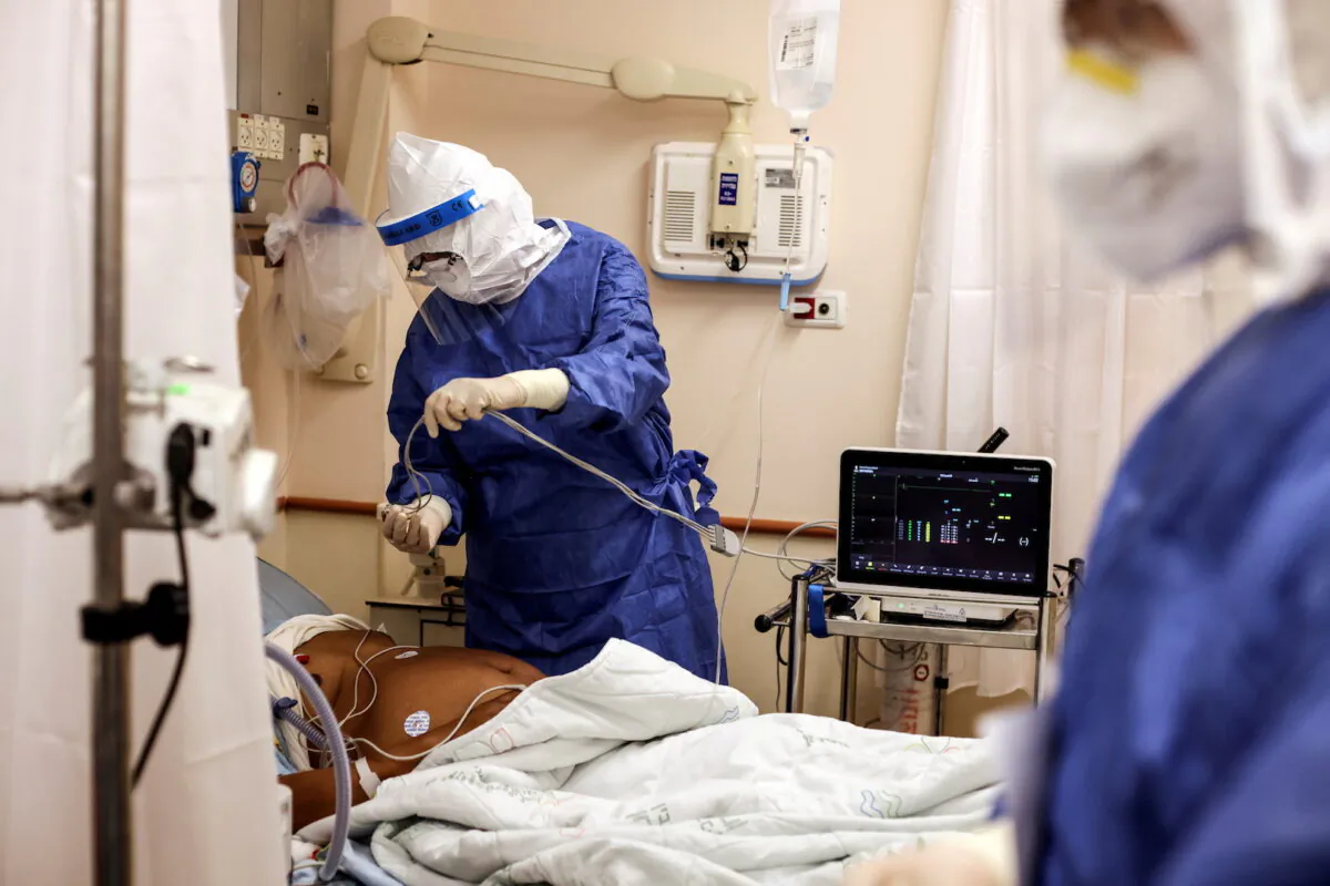 A medical staff member attends a patient suffering from COVID-19 in a ward at Beilinson Hospital in Petah Tikva, Israel, on Aug. 18, 2021. (Ammar Awad/File Photo via Reuters)