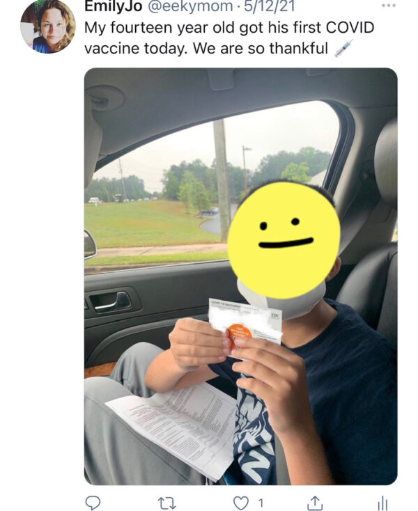 Aidan showing vaccine card