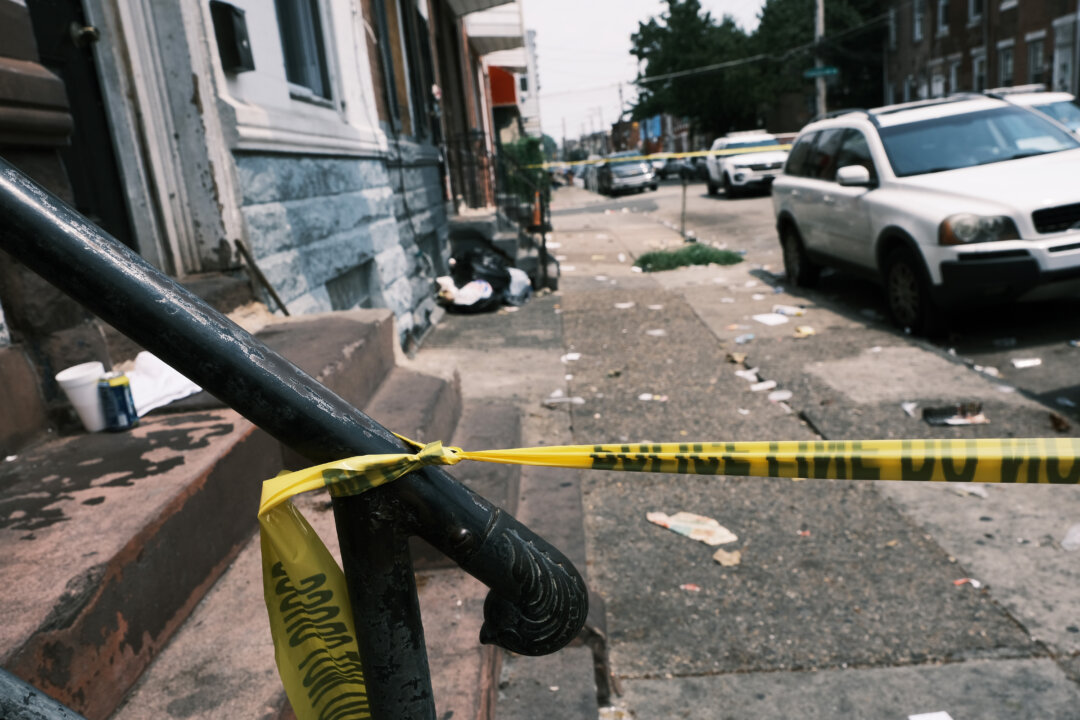 Police tape blocks a street where a person was shot in a drug related event in Philadelphia, Pa., on July 19, 2021. (Spencer Platt/Getty Images)