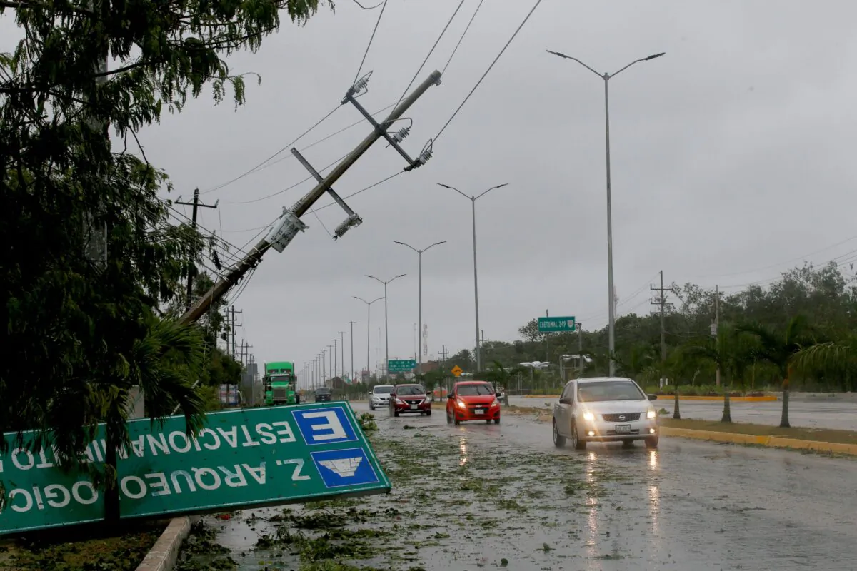 A road sign brought down by the winds of Hurricane Grace lays on the side of the highway in Tulum, Quintana Roo state, Mexico, on Aug.19, 2021. (Marco Ugarte/AP Photo)