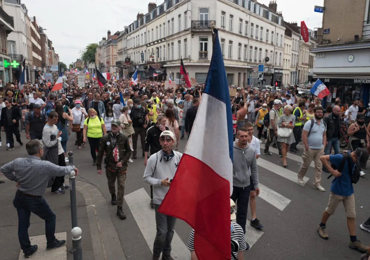 Demonstrators march during a rally against the COVID-19 health pass in Lille, northern France, on Aug. 21, 2021. (Michel Spingler /AP Photo)