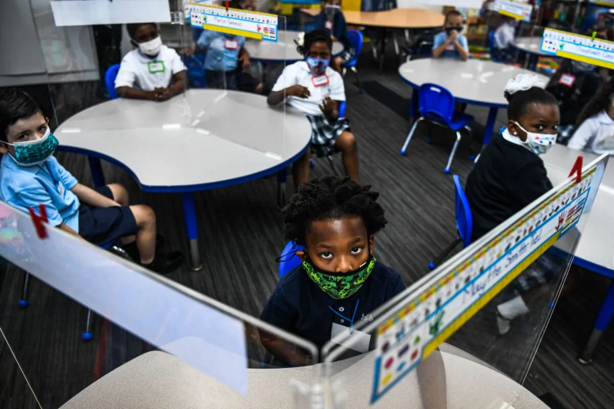 Student wear facemasks as they attend their first day in school after summer vacation at the St. Lawrence Catholic School in north of Miami on Aug. 18, 2021. (Photo by CHANDAN KHANNA / AFP) (Photo by CHANDAN KHANNA/AFP via Getty Images)