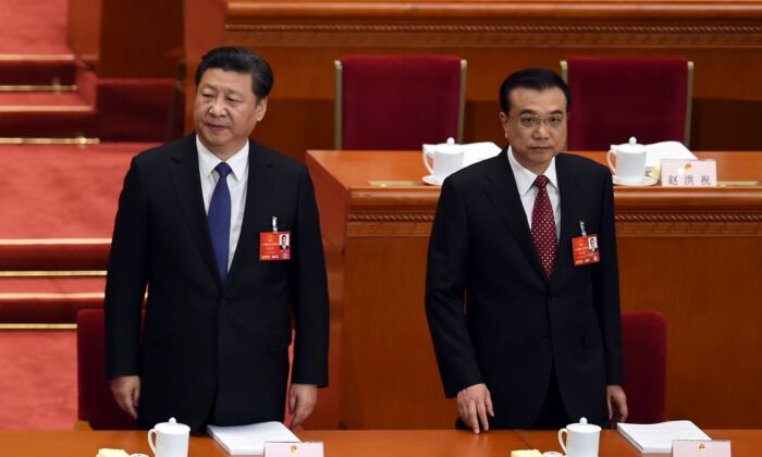Chinese leader Xi Jinping (L) and Premier Li Keqiang arrive for the opening ceremony of the rubber-stamp legislature’s congress in Beijing on March 5, 2016. (Wang Zhao/AFP via Getty Images)