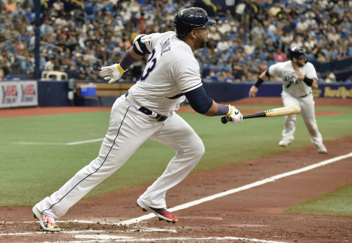 Tampa Bay Rays' Mike Zunino, background, races home to score on an infield ground ball hit by Nelson Cruz, foreground, off Chicago White Sox starter Dallas Keuchel during the second inning of a baseball game in St. Petersburg, Fla., on Aug. 21, 2021. (Steve Nesius/AP Photo)