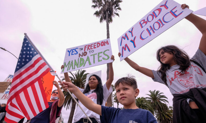 Protesters hold signs as they demonstrate during a "No Vaccine Passport Rally," in Santa Monica, Calif., on August 21, 2021. (Ringo Chiu/AFP via Getty Images)