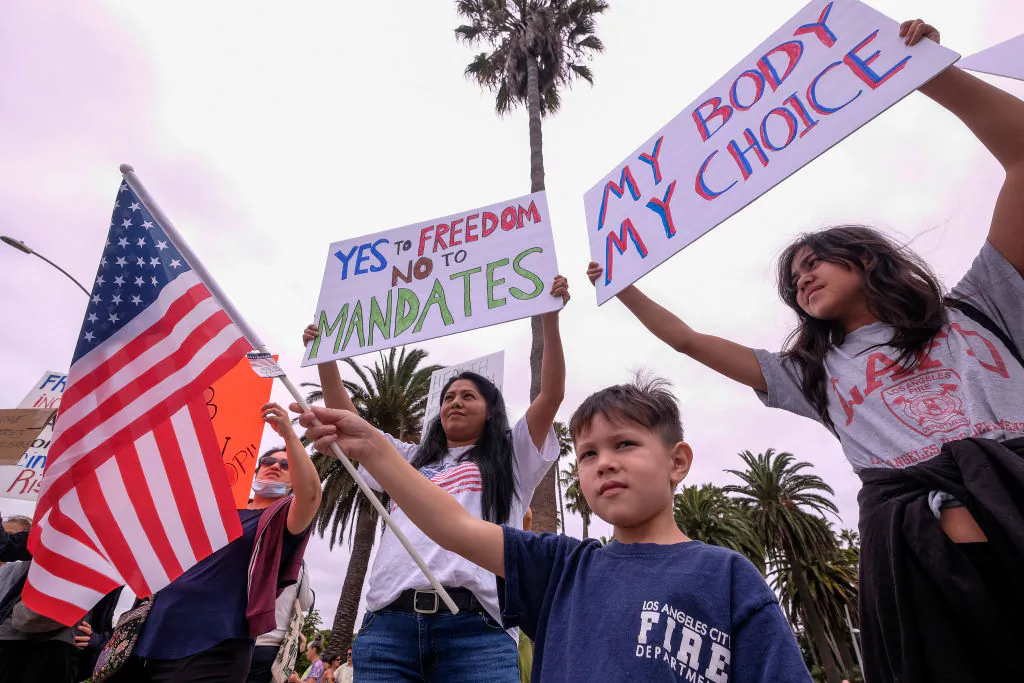 Protesters hold signs as they demonstrate during a "No Vaccine Passport Rally," in Santa Monica, Calif., on Aug. 21, 2021. (Ringo Chiu/AFP via Getty Images)